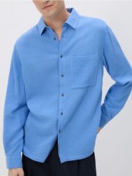 Muślinowa koszula regular fit - niebieski. Niebieskie koszule Reserved, l, bez wzorów, z bawełny, bez kołnierzyka, bez ramiączek. Za 119.99 zł.