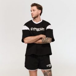 Szorty męskie fitness oversize ze sznurkiem Varsity czarne. Czarne krótkie spodenki sportowe GYMBEAM, l, bez wzorów, z bawełny. Za 105.90 zł.