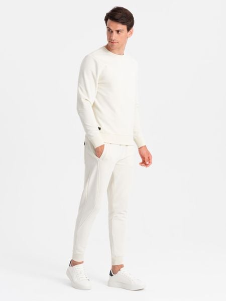 Bawełniany dresowy komplet męski BASIC bluza nierozpinana + joggery – kremowy V5 - Rozmiar: M. Białe joggery i bojówki Ombre Clothing, m, bez wzorów, z bawełny. Za 269.99 zł.