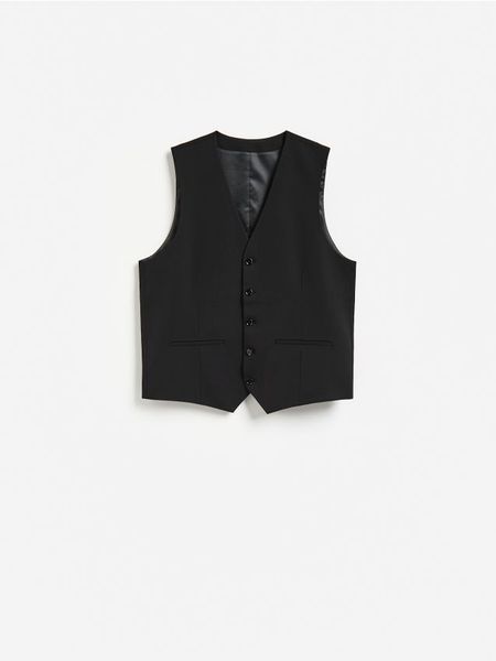 Garniturowa kamizelka - czarny. Czarne garnitury Reserved, l, bez wzorów, z tkaniny. Za 159.99 zł.