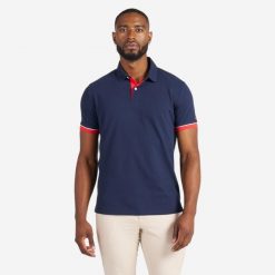 Polo żeglarskie męskie Tribord Sailing 100 krótki rękaw. Niebieskie koszulki polo TRIBORD, l, bez wzorów, z bawełny, bez kołnierzyka, bez ramiączek, żeglarskie. Za 69.99 zł.