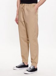 Converse Joggery Star Chevron 10024606-A02 Beżowy Regular Fit. Brązowe joggery i bojówki Converse, m, bez wzorów, z bawełny, retro. Za 199.99 zł.