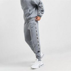 Spodnie Dresowe Męskie Nike Nsw Repeat Tape Jogger. Szare joggery i bojówki Nike, m, bez wzorów, z dresówki, sportowe. Za 215.60 zł.